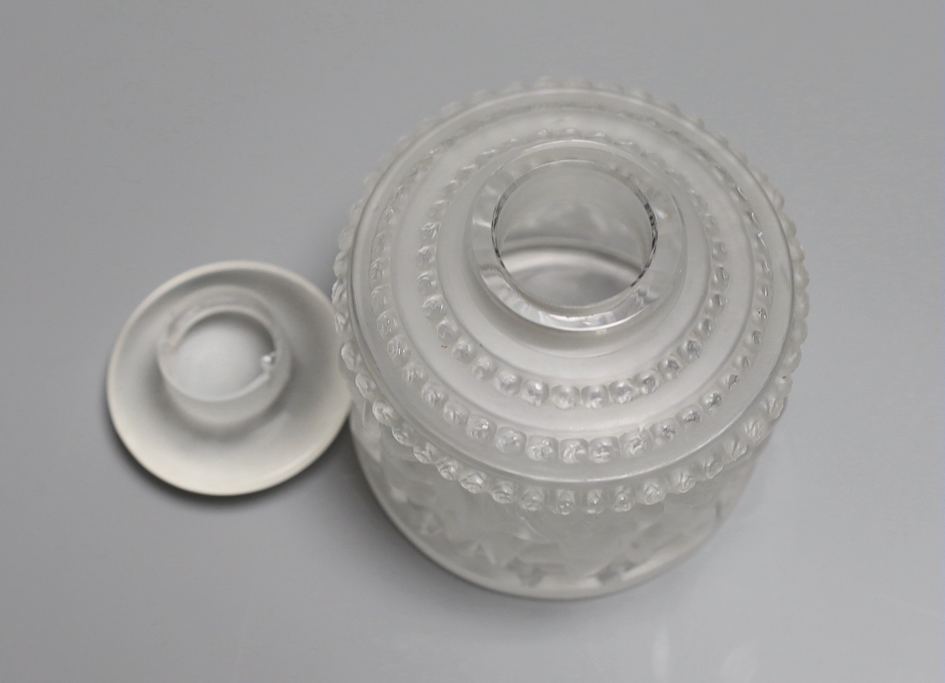 A Lalique Les Enfants pattern glass jar and cover. 30cm tall